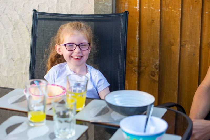 A smiling girl sitting at a table