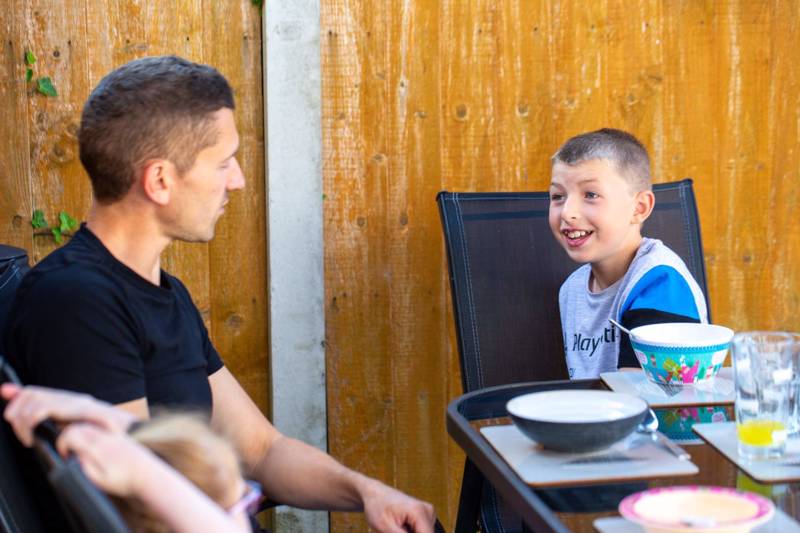 Dad with two children laughing at the table